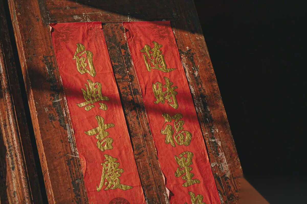 Red couplets go up on doorways before New Year.